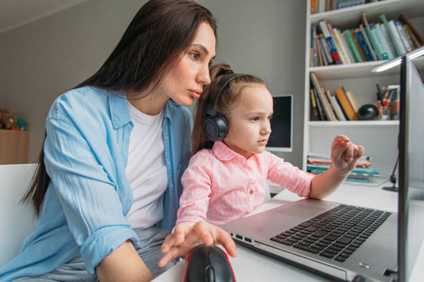 istock mom helps daughter do homework remotely on laptop 1346686800