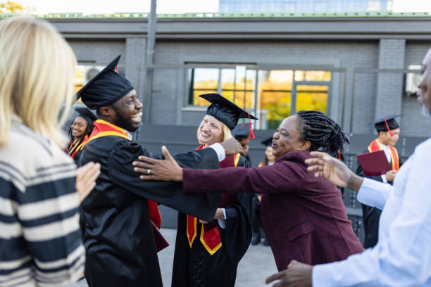 istock Mixed - race couple on graduation ceremony 1346686988