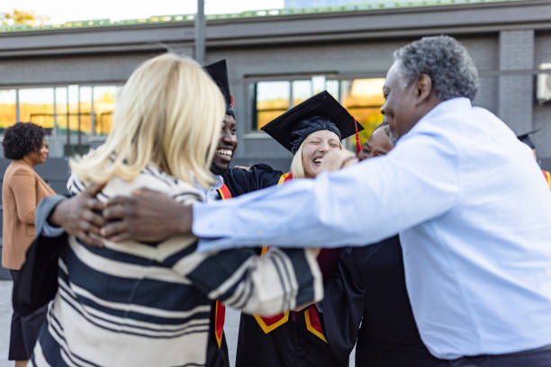 istock Mixed - race couple on graduation ceremony 1346687002