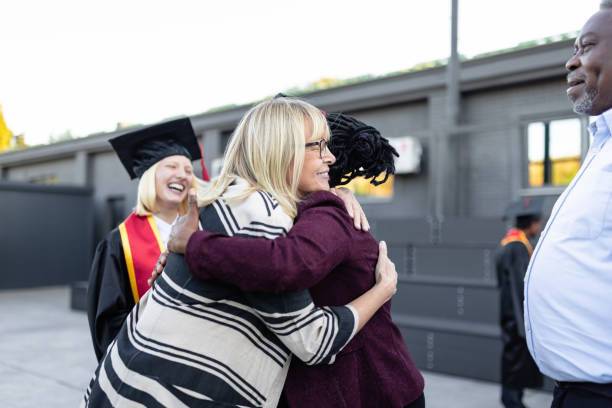 istock Mixed - race couple on graduation ceremony 1346687022