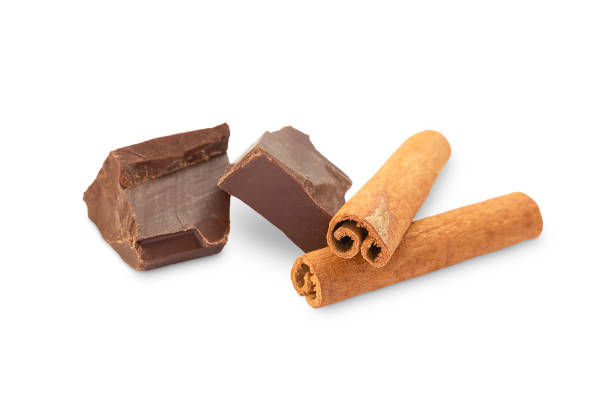 istock two pieces of chocolate and two cinnamon sticks on a white background 1346687109