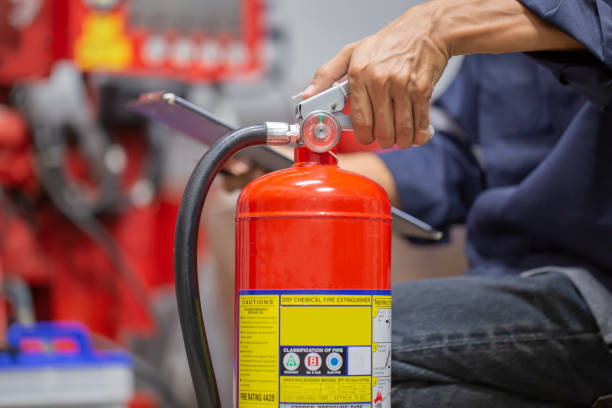 istock Engineer are checking and inspection a fire extinguishers tank in the fire control room for safety training and fire prevention. 1346687738