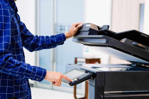 istock Businessmen press button on the panel for using photocopier or printer for printout and scanning document paper at office. 1346687797