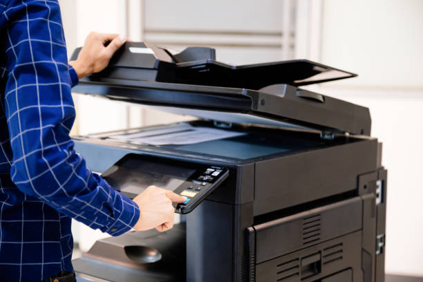istock Businessmen press button on the panel for using photocopier or printer for printout and scanning document paper at office. 1346687809