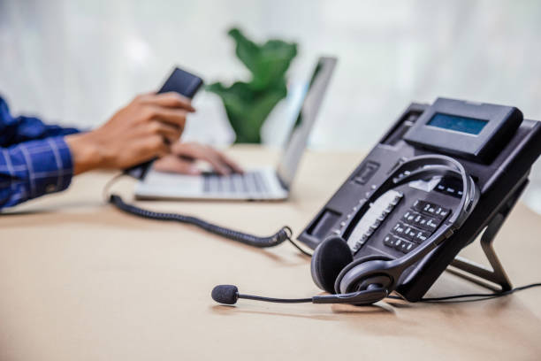 istock Communication support, call center and customer service help desk. telephone devices with VOIP headset in office.Customer service support (call center) concept. 1346687837