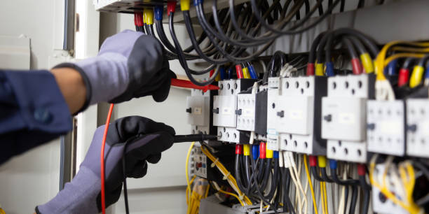 istock Electrician engineer tests electrical installations and wires on relay protection system. Adjustment of scheme of automation and control of electrical equipment. 1346687910