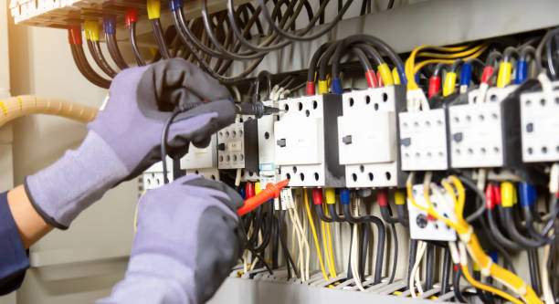 istock Electrician engineer tests electrical installations and wires on relay protection system. Adjustment of scheme of automation and control of electrical equipment. 1346687916