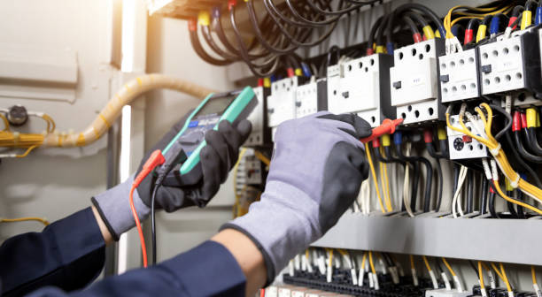 istock Electrician engineer tests electrical installations and wires on relay protection system. Adjustment of scheme of automation and control of electrical equipment. 1346687922
