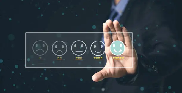 Photo of Customer Service and Satisfaction Concept Businessmen touch the virtual screen on happy smiley icons to achieve service satisfaction and feedback with excellent rated reviews.