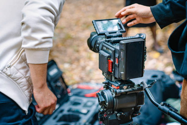 Midsection Of Man Holding Movie Camera Photo taken in Bucharest, Romania cinematography stock pictures, royalty-free photos & images