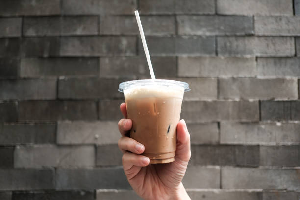 istock Iced coffee in plastic glass at cafe for take away 1346690026