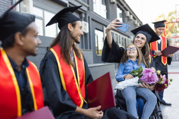 istock Group of students having fun after  graduation ceremony. 1346690698