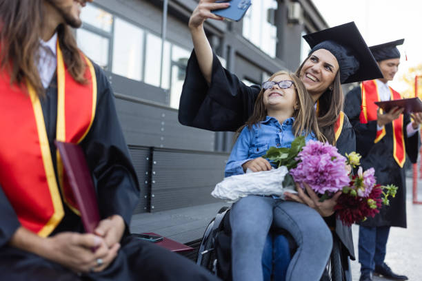 istock Group of students having fun after  graduation ceremony. 1346690702