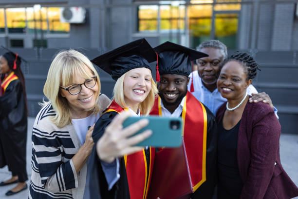 istock Students after graduation ceremony with their family 1346690713