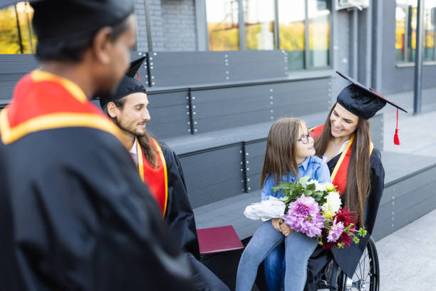 istock Group of students having fun after  graduation ceremony. 1346690715
