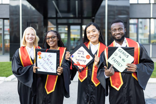 istock Portrait of students after graduation ceremony 1346690734