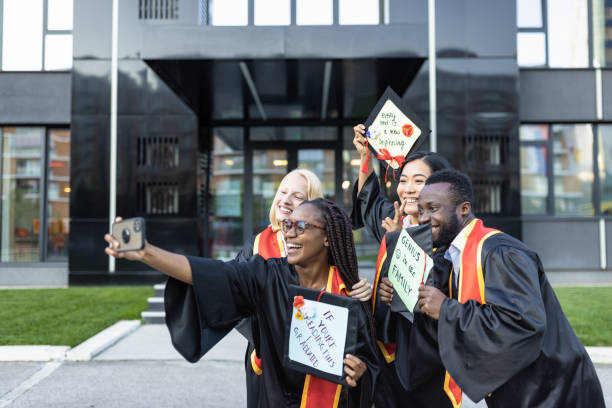 istock Students after graduation ceremony taking selfie 1346690746