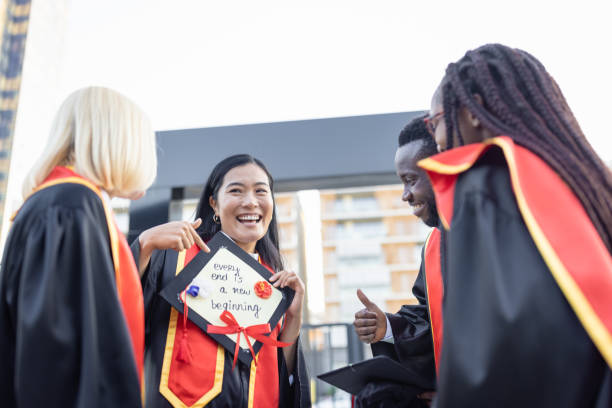 istock Students after graduation ceremony having fun 1346690760