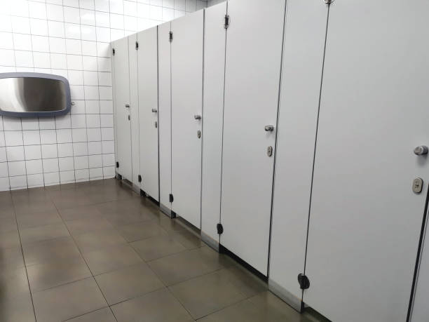 istock White public bathroom door with clean tiled floor. 1346691694