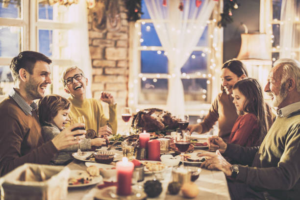 istock Happy multi-generation family enjoying in conversation during Thanksgiving lunch at dining table. 1346693312