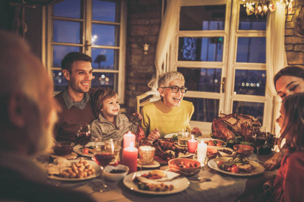 istock Happy extended family talking during Thanksgiving dinner at home. 1346694434