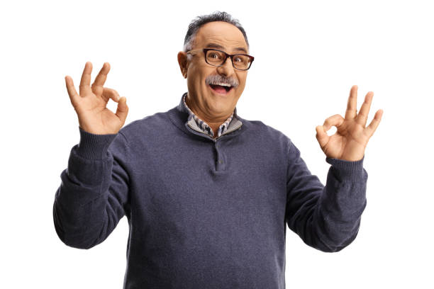istock Mature man smiling and gesturing ok sign 1346695165