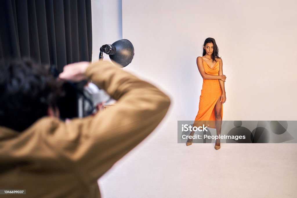 Shot of a photographer taking photos of a model in a studio You are the most beautiful creature Fashion Model Stock Photo