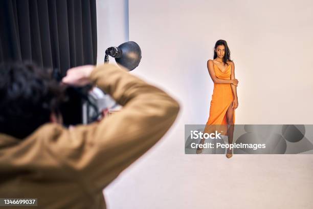 Shot Of A Photographer Taking Photos Of A Model In A Studio Stock Photo - Download Image Now