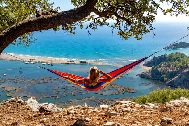 istock Happy woman in hammock watching Iztuzu beach. 1346699367