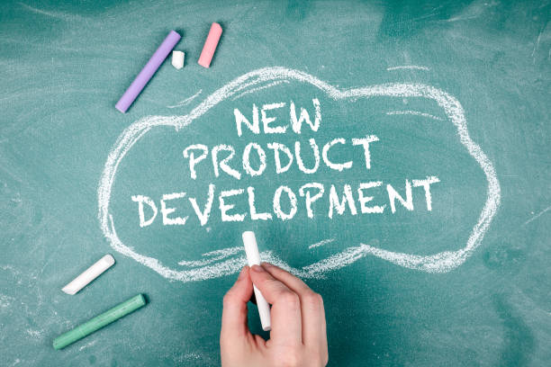 istock New Product Development. Cloud and pieces of chalk on a green board 1346699593