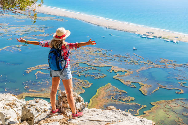 istock Walking woman looking at the beach. 1346699893