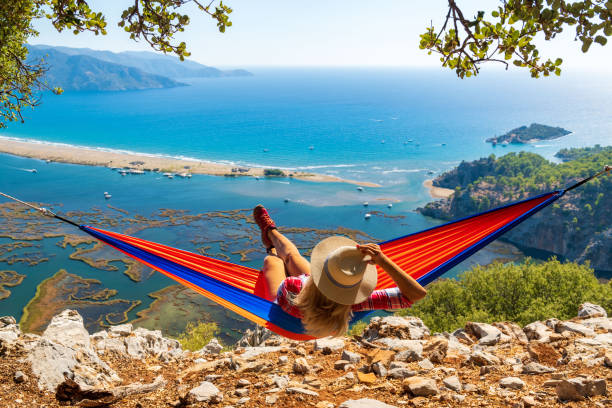 istock Happy woman in hammock watching Iztuzu beach. 1346699962
