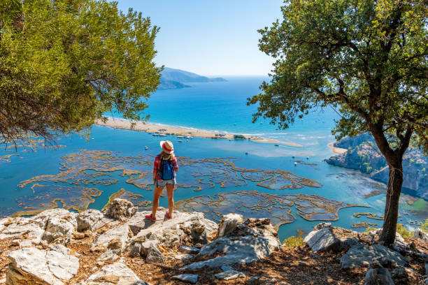 istock Walking woman looking at the beach. 1346700868