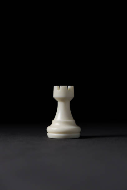 isolated white rook chess piece on black background