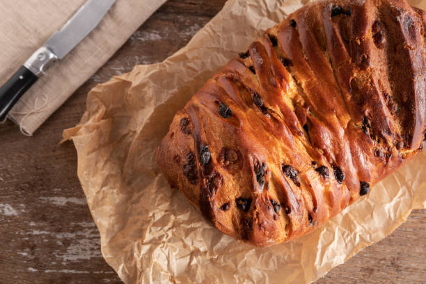 Brioche with chocolate chips on wooden background