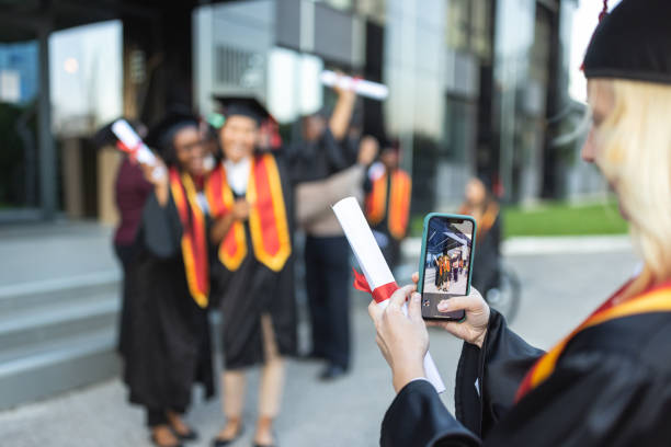 istock Graduation. Students photographing each other 1346701300
