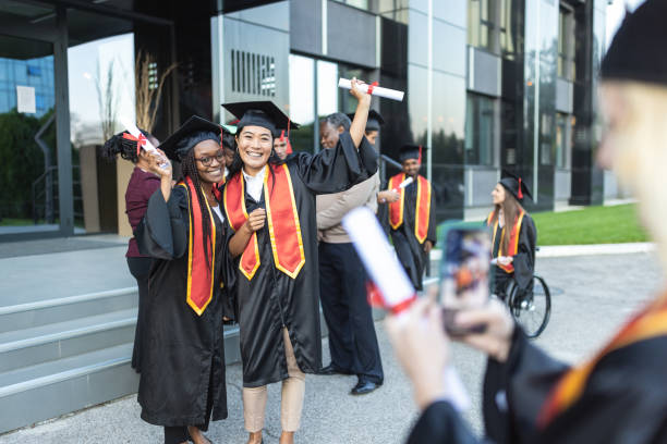 istock Graduation. Students photographing each other 1346701323