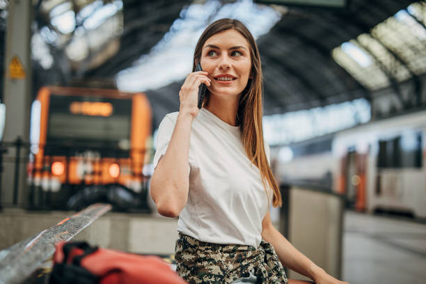 istock Beautiful woman on train station 1346702291
