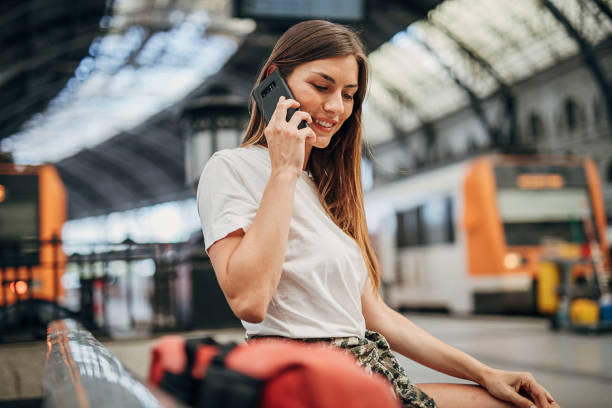 istock Beautiful woman on train station 1346702332