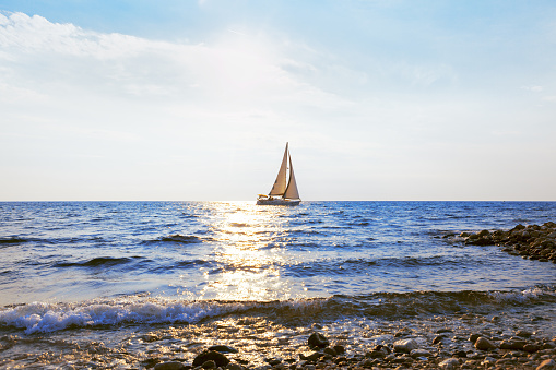 Sailing yacht in sunlight . Yacht view from the coast