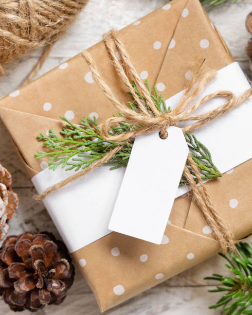 istock Christmas present with blank gift tag top view, Mockup 1346703848