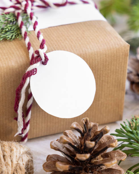 istock Christmas present with round blank gift tag close up, Mockup 1346703862