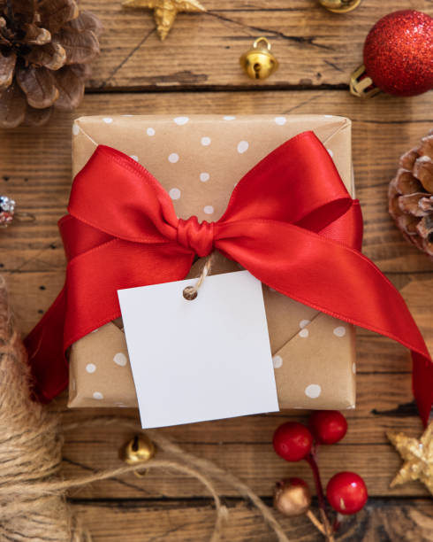 istock Christmas Gift Box with square blank gift tag top view 1346703863