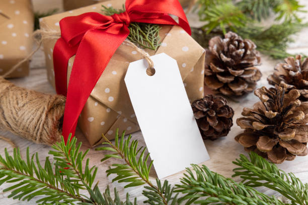 istock Christmas present with blank gift tag and decorations, Mockup 1346703868
