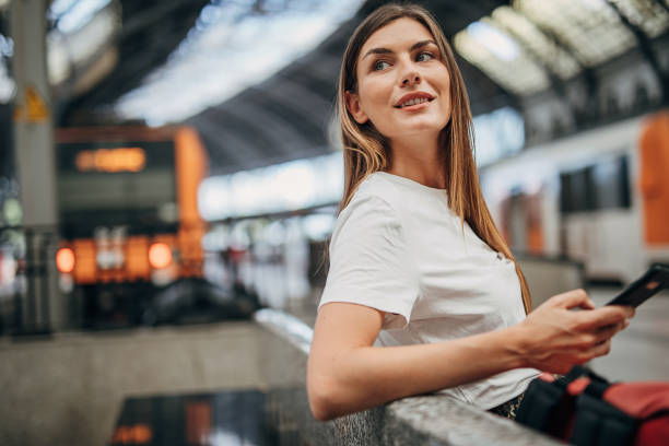 istock Woman sitting on train station 1346704636