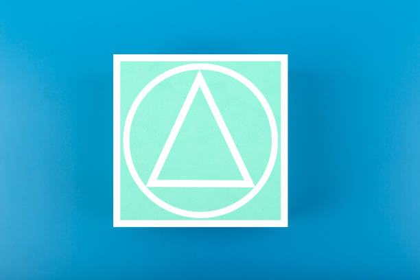 Squid Game Korean movie concept. Circle, triangle and square drawn on big aqua blue cube on dark blue background. Minimal background with Squid Game movie symbols
