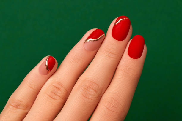 Womans hand with fashionable red manicure close up. Christmas new year nail design Womans hand with fashionable red manicure close up. Christmas new year nail design. Manicure, pedicure beauty salon concept. christmas nails stock pictures, royalty-free photos & images