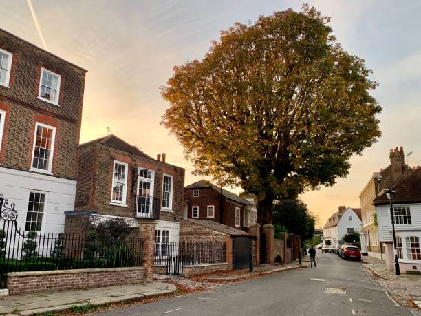 Golden hour in Chiswick. Street view Golden hour in capital of UK. Chiswick street view. Old tudor and Georgian brick houses with front gardens. Autumn. Vanilla sky, sunset. Vertical. Selective focus chiswick stock pictures, royalty-free photos & images