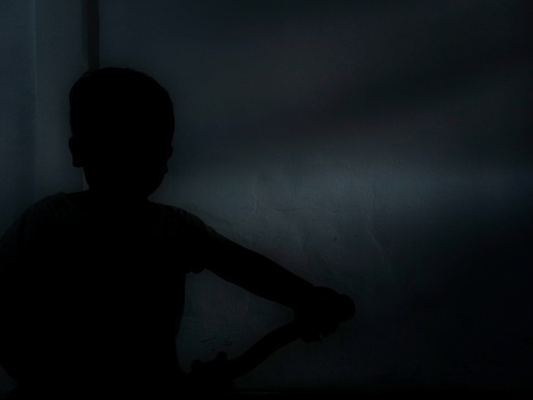 Silhouette of a child in the house