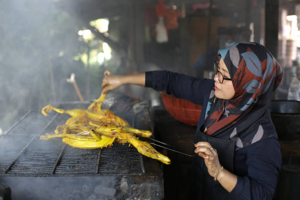 A Muslim woman is preparing smoked duck.
